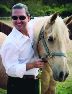 Dr. Newall standing with horse