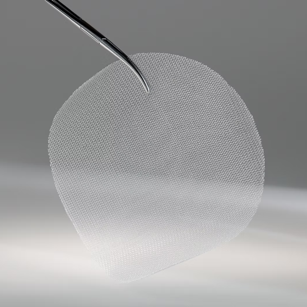 A close-up view of a textured, teardrop-shaped breast implant being handled with surgical forceps.